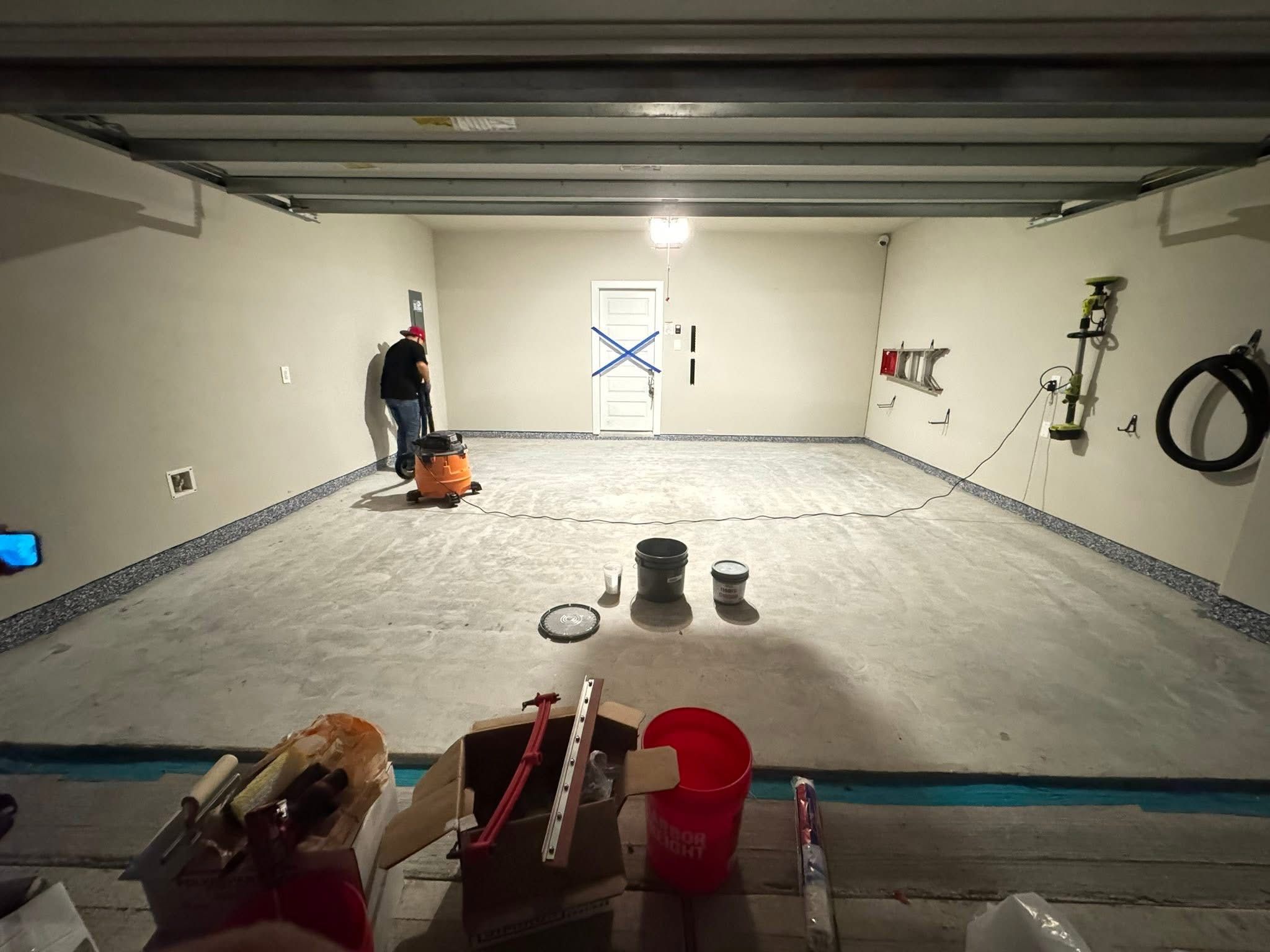 Garage floor before epoxy — bare concrete during preparation